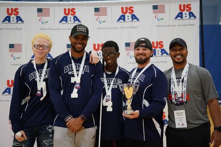 The Atlanta Wolves goalball team poses with their trophy at a USABA tournament