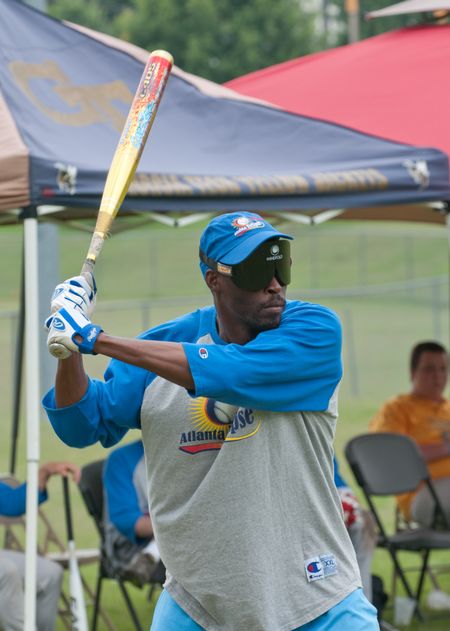 A blindfolded batter for the Atlanta Eclipse swings during a beep baseball game