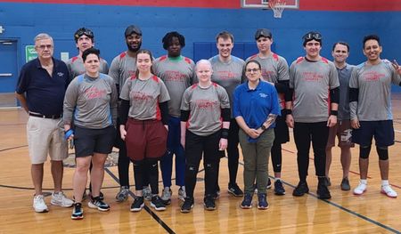 The Atlanta goalball team poses together on the court after a match