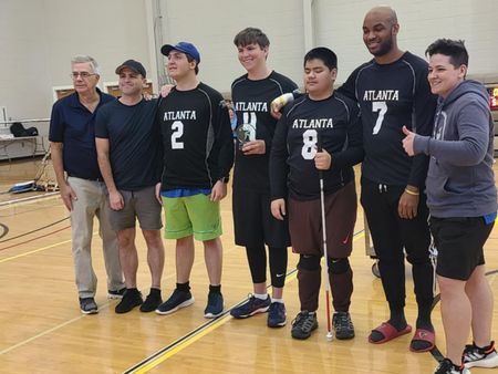 Atlanta goalball players celebrate with a tournament trophy