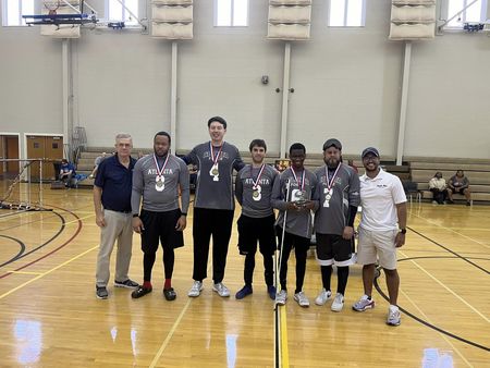The Atlanta Force goalball team poses with their trophy after a championship win