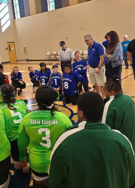 Savannah and South Carolina goalball teams listen to coaches between plays at a tournament